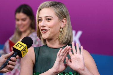 American actress Lili Reinhart wearing Miu Miu is interviewed by Entertainment Tonight (ET) at the Los Angeles Premiere Of Netflix's 'Look Both Ways' held at the Netflix Tudum Theater on August 16, 2022 in Hollywood, Los Angeles, California