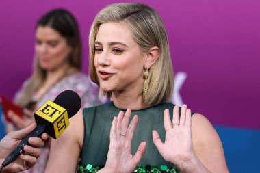 American actress Lili Reinhart wearing Miu Miu is interviewed by Entertainment Tonight (ET) at the Los Angeles Premiere Of Netflix's 'Look Both Ways' held at the Netflix Tudum Theater on August 16, 2022 in Hollywood, Los Angeles, California