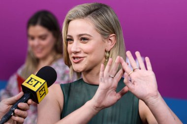 American actress Lili Reinhart wearing Miu Miu is interviewed by Entertainment Tonight (ET) at the Los Angeles Premiere Of Netflix's 'Look Both Ways' held at the Netflix Tudum Theater on August 16, 2022 in Hollywood, Los Angeles, California