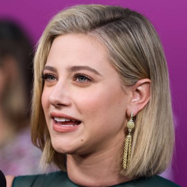 American actress Lili Reinhart wearing Miu Miu is interviewed by Entertainment Tonight (ET) at the Los Angeles Premiere Of Netflix's 'Look Both Ways' held at the Netflix Tudum Theater on August 16, 2022 in Hollywood, Los Angeles, California