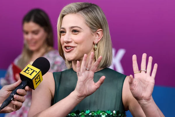 American actress Lili Reinhart wearing Miu Miu is interviewed by Entertainment Tonight (ET) at the Los Angeles Premiere Of Netflix's 'Look Both Ways' held at the Netflix Tudum Theater on August 16, 2022 in Hollywood, Los Angeles, California