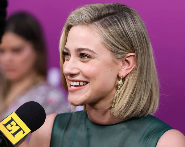American actress Lili Reinhart wearing Miu Miu is interviewed by Entertainment Tonight (ET) at the Los Angeles Premiere Of Netflix's 'Look Both Ways' held at the Netflix Tudum Theater on August 16, 2022 in Hollywood, Los Angeles, California