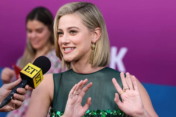 American actress Lili Reinhart wearing Miu Miu is interviewed by Entertainment Tonight (ET) at the Los Angeles Premiere Of Netflix's 'Look Both Ways' held at the Netflix Tudum Theater on August 16, 2022 in Hollywood, Los Angeles, California
