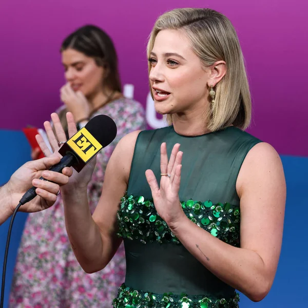 American actress Lili Reinhart wearing Miu Miu is interviewed by Entertainment Tonight (ET) at the Los Angeles Premiere Of Netflix's 'Look Both Ways' held at the Netflix Tudum Theater on August 16, 2022 in Hollywood, Los Angeles, California