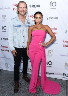 Canadian entrepreneur and Founder of Mindful Media PR Michael Graziano and wife/British YouTuber Natasha Grano Graziano arrive at the Eugenia Kuzmina And Playboy Launch Reception held at The Godfrey Hotel Hollywood on August 18, 2022 in Hollywood