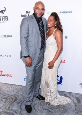 American professional basketball coach and former player who is the head coach of the Los Angeles Lakers of the National Basketball Association Darvin Ham and wife Deneitra Ham arrive at the 22nd Annual Harold And Carole Pump Foundation Gala 