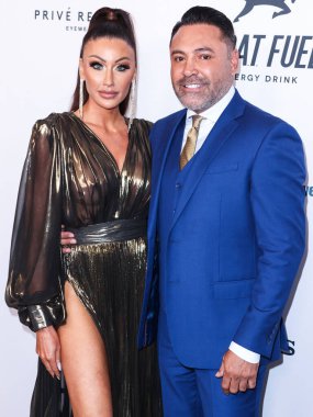 American golfer and model Holly Sonders and boyfriend/American boxing promoter and former professional boxer Oscar De La Hoya arrive at the 22nd Annual Harold And Carole Pump Foundation Gala held at The Beverly Hilton Hotel on August 19, 2022 in Beve