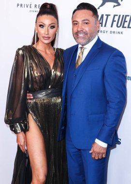 American golfer and model Holly Sonders and boyfriend/American boxing promoter and former professional boxer Oscar De La Hoya arrive at the 22nd Annual Harold And Carole Pump Foundation Gala held at The Beverly Hilton Hotel on August 19, 2022 in Beve
