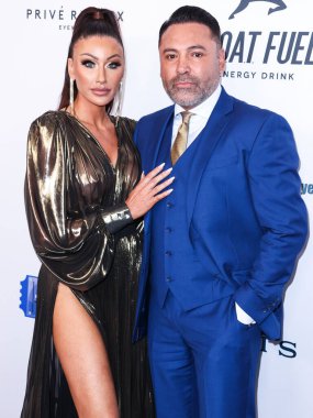 American golfer and model Holly Sonders and boyfriend/American boxing promoter and former professional boxer Oscar De La Hoya arrive at the 22nd Annual Harold And Carole Pump Foundation Gala held at The Beverly Hilton Hotel on August 19, 2022 in Beve