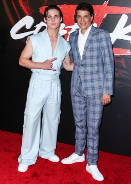 Tanner Buchanan and Ralph Macchio arrive at the Los Angeles Premiere Of Netflix's 'Cobra Kai' Season 5 held at the Los Angeles State Historic Park on September 7, 2022 in Los Angeles, California, United States. 