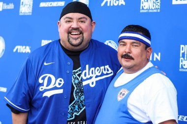 American comedian Gabriel Iglesias (Fluffy) and Mexican-American talk show personality Guillermo Rodriguez arrive at Kershaw's Challenge Ping Pong 4 Purpose 2022 held at Dodger Stadium on August 8, 2022 in Elysian Park, Los Angeles, California clipart
