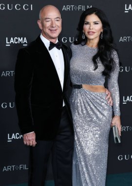 American entrepreneur and executive chairman of Amazon.com Jeff Bezos and girlfriend/American news anchor Lauren Sanchez arrive at the 10th Annual LACMA Art + Film Gala 2021 held at the Los Angeles County Museum of Art on November 6, 2021 in LA, USA. clipart