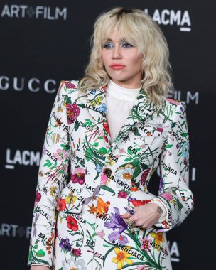 Singer Miley Cyrus wearing a Gucci X Balenciaga suit and Jared Lehr jewelry arrives at the 10th Annual LACMA Art + Film Gala 2021 held at the Los Angeles County Museum of Art on November 6, 2021 in Los Angeles, California, United States.