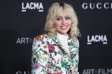 Singer Miley Cyrus wearing a Gucci X Balenciaga suit and Jared Lehr jewelry arrives at the 10th Annual LACMA Art + Film Gala 2021 held at the Los Angeles County Museum of Art on November 6, 2021 in Los Angeles, California, United States.