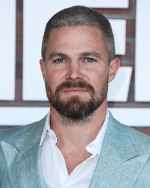 Scarosso ayakkabılı bir Giorgio Armani takım elbise giyen aktör Stephen Amell, 10 Ağustos 2021 'de Los Angeles' taki Sacramento Caddesi 2137 numaradaki STARZ 's Heels' in Los Angeles galasına geldi.. 