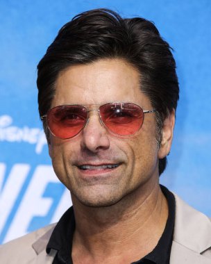 Actor John Stamos arrives at the Disney+ 'Turner & Hooch' Los Angeles Premiere Event held at the Westfield Century City Mall on July 15, 2021 in Century City, Los Angeles, California, United States.