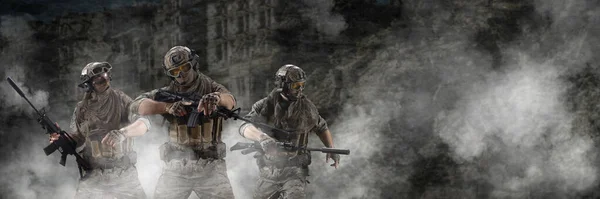 Three mercenary soldiers during a special operation in the smoke against the background of a ruins - photo with copy space. Format photo 3x1. Collage - one model, in three poses. — Stock Photo, Image