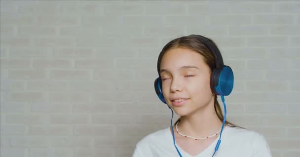 Adolescente em um fone de ouvido ouvindo a música calma. — Vídeo de Stock