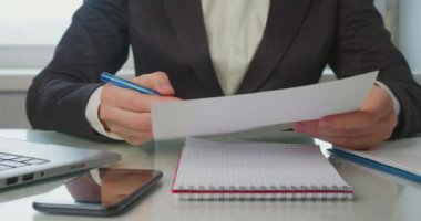Ofisteki kadın vergi raporlarını, belgelerini ve formlarını kontrol ediyor, kritik bir hata buluyor, kağıdı öfkeyle buruşturup atıyor..
