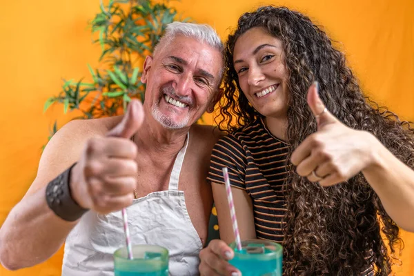 Father Daughter Drinking Blue Cocktail Doing Thumb Sign Hands Studio — стоковое фото