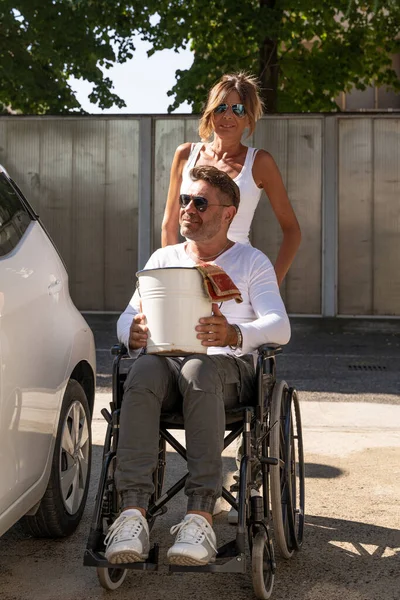 Happy Middle Aged Couple Man Sitting Wheelchair Washing Car Public — Photo