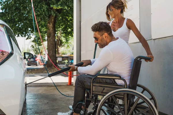Happy Middle Aged Couple Man Sitting Wheelchair Washing Car Public — 스톡 사진
