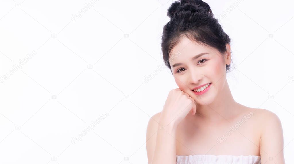 Asian young woman looking at camera with clear fresh skin. Teenager with perfect treatment skin over isolated white background. Beauty, cosmetics, healthy, treatment, skincare and spa concept.