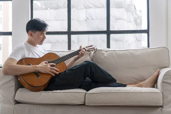 Happy Asian Handsome Man Playing Acoustic Guitar Sitting Sofa Relax — Fotografia de Stock