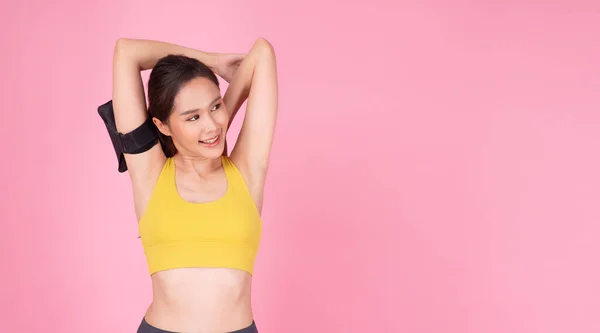 Cheerful Slim Asian Women Wear Yellow Sportswear Stretching Arms Looking — Stok fotoğraf