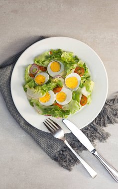Vegetable salad, bowls, and plates with food top view  