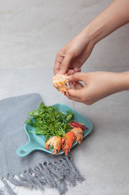 Boiled shrimp, coriander, pickled onion, owls, and plates with food top view