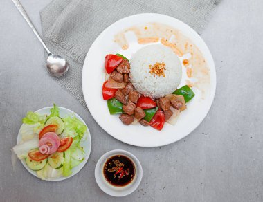 Vietnamese Shaking Beef, salad,  bowls, and plates with food top view