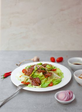 Vietnamese Salad Shaking Beef,  bowls, and plates with food top view