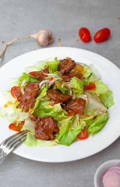 Vietnamese Salad Shaking Beef,  bowls, and plates with food top view