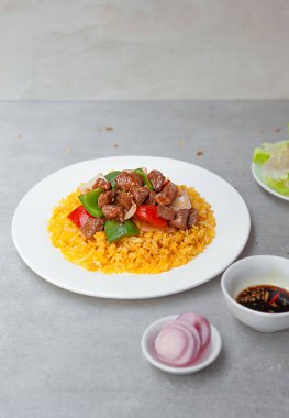 Vietnamese Shaking Beef, salad,  bowls, and plates with food top view