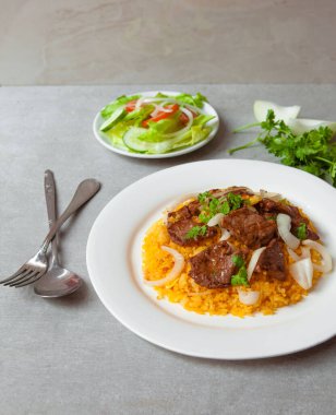 Vietnamese Shaking Beef, salad,  bowls, and plates with food top view