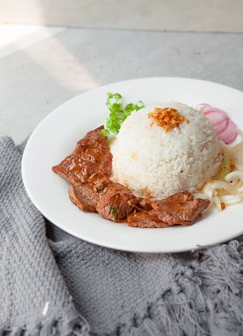 Vietnamese Shaking Beef, salad,  bowls, and plates with food top view