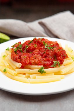 Pasta tomato sauce, owls, and plates with food top view