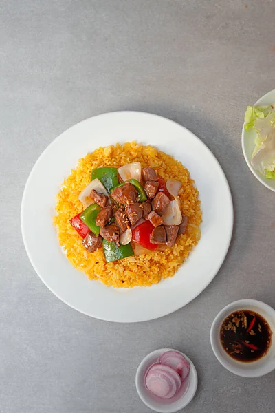 Vietnamese Shaking Beef, salad,  bowls, and plates with food top view