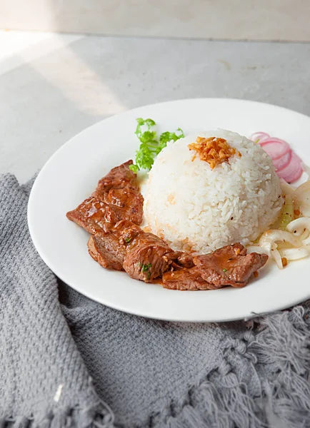 Vietnamese Shaking Beef, salad,  bowls, and plates with food top view