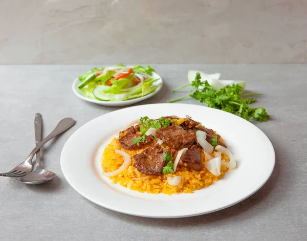 Vietnamese Shaking Beef, salad,  bowls, and plates with food top view