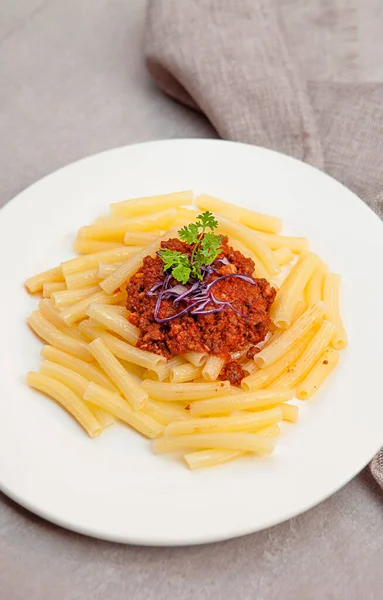 Pasta tomato sauce, owls, and plates with food top view