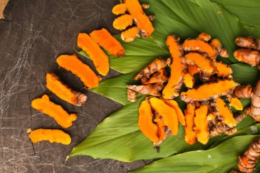 Turmeric powder is isolated on old rustic wood table backgrounda beauty and spa concept.