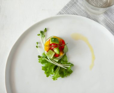 Vegetable salad, bowls, and plates with food top view