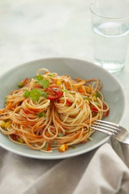 Tomato sauce pasta, bowls, and plates with food top view