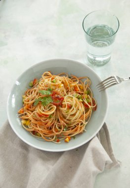 Tomato sauce pasta, bowls, and plates with food top view