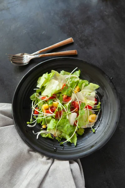 Vegetable salad, bowls, and plates with food top view