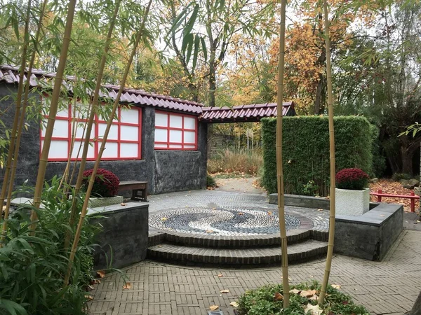 Japanese garden patio.Patio with benches and bamboos in autumn. Castle Gardens Arcen (Kasteeltuinen Arcen) is beautiful garden complex on a 32 hectare property with 15 unique gardens created around a historic country seat with a 17th century castle