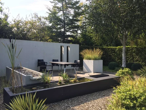 Appeltern, Netherlands, September 16, 2020. Appeltern is the Netherlands' largest garden idea park. Garden with walls. Modern garden terrace behind the water basin and between the white walls