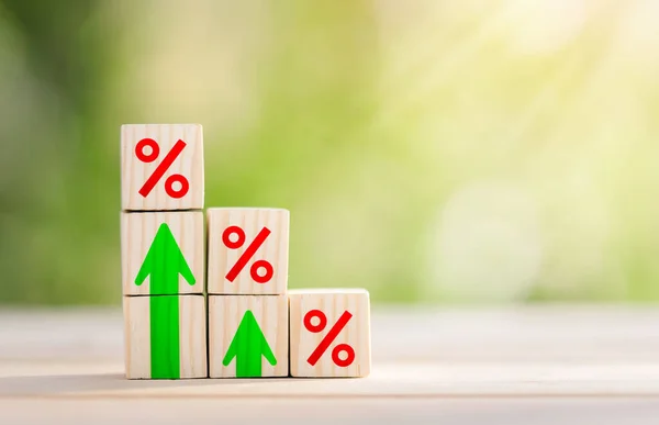 Interest rate financial and mortgage rates concept. Wooden blocks are lined up in steps with up arrow and interest symbols. Mortgage rates business concept of investment,  interest rates appraisal